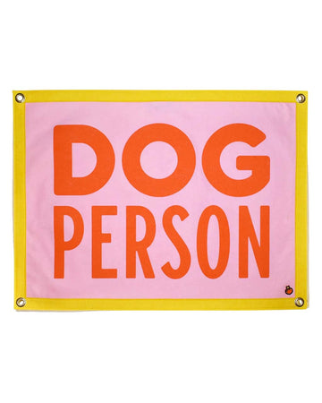 pink wool pennant with yellow border and orange 'dog person' across the front