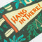 up close of 'hang in there' card and pennant