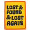 yellow wool flag with orange banner and black 'lost & found & lost again'