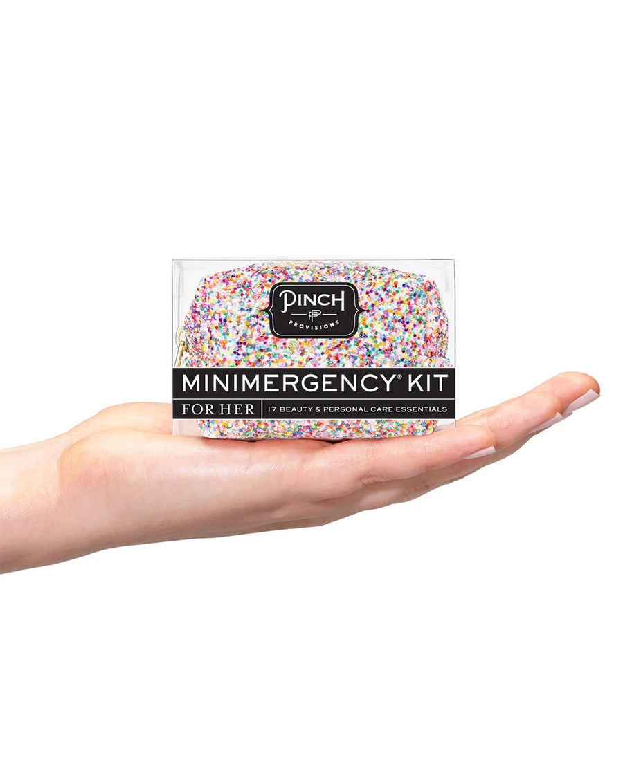 model holding multicolor glitter minimergency kit in the palm of their hand