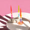 orange/purple, neon yellow/blue and red/pink swirl candle set of 3 in a candle holder