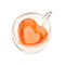 top view of heart shaped clear glass mug with peach liquid inside