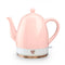 pink ceramic electric tea kettle off of rose gold base