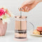 model using rose gold mini glass tea press with silver press pieces