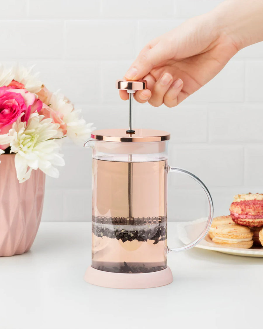 model using rose gold mini glass tea press with silver press pieces