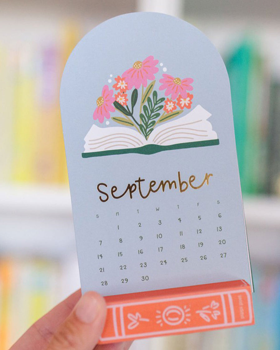 model holding september mini desk calendar