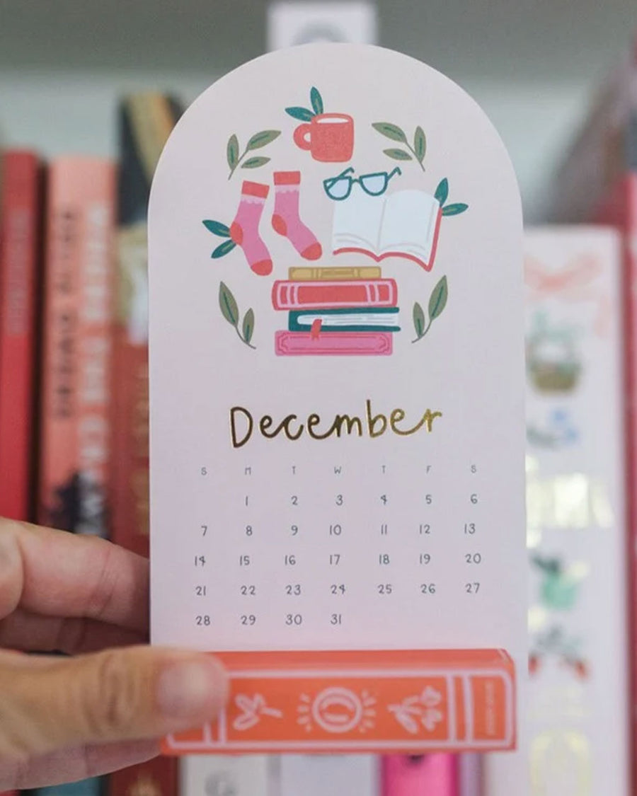 model holding december mini desk calendar