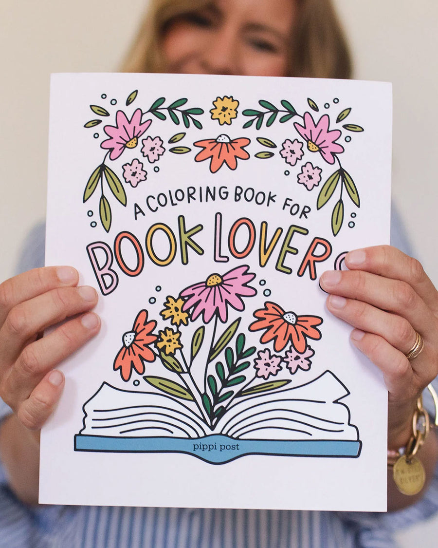 model holding 'a coloring book for book lovers'