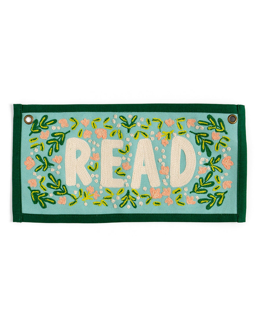 7 in. x 14 in. rectangular embroidered wall hanging with 'read' across the front displayed on a wall