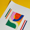 journal with "The Creativity Journal" printed in gold and covered in colorful waves on a yellow background