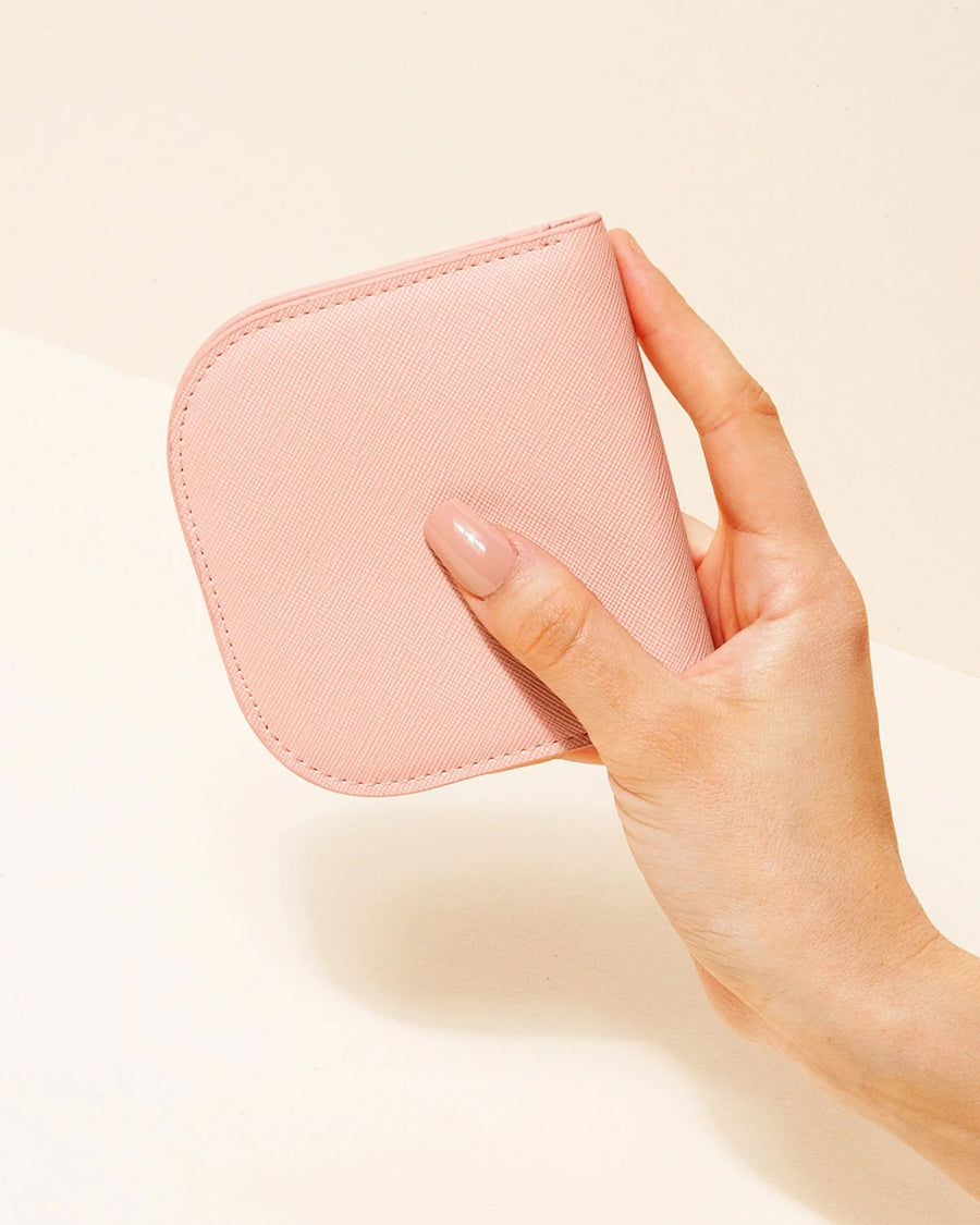 model holding pink dome wallet
