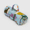 folded light blue puffy picnic blanket with colorful table cats print