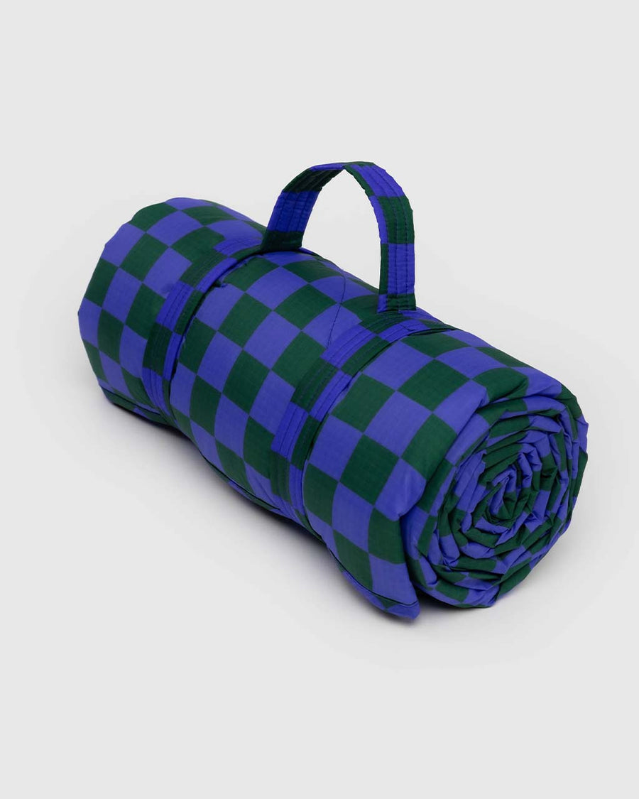 folded puffy picnic blanket with green and bright blue checker print