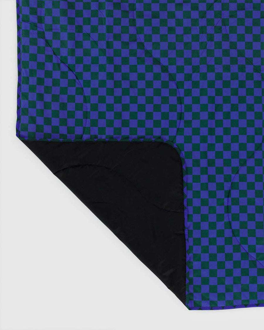 black bottom of puffy picnic blanket with green and bright blue checker print