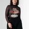 model wearing black sheer long sleeve top with turtleneck and seafood tower graphics with black skirt