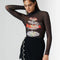 side view of model wearing black sheer long sleeve top with turtleneck and seafood tower graphics