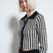 model wearing black and white vertical stripe top with collar and zipper front with matching pants