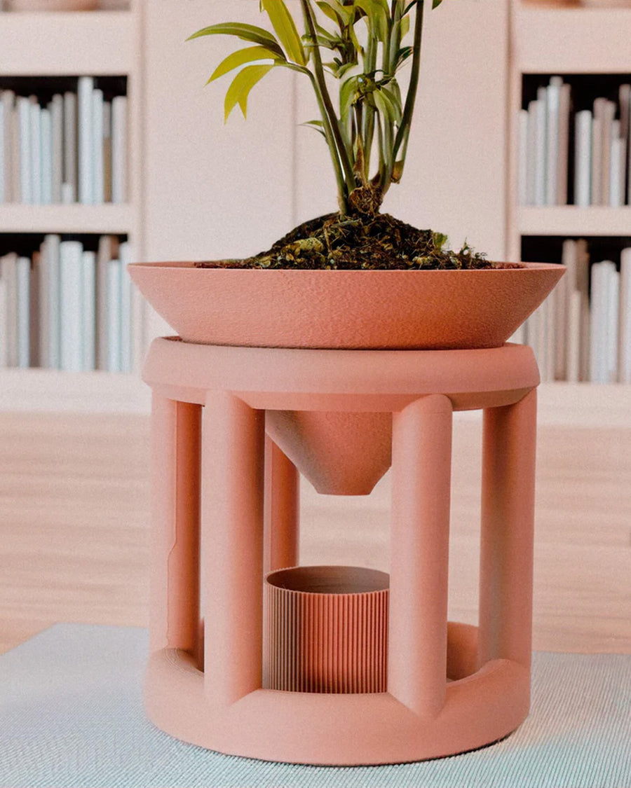 copper colored 3d printing planter with drip tray in a plant