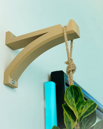 beige curved hanger planter hook on a wall