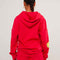 back view of model wearing red hoodie with yellow smiley print on sleeves