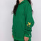 side view of model wearing kelly green hoodie with woodstock and snoopy print on sleeves