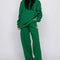 model wearing kelly green sweatpants with slit pockets and woodstock and snoopy print on sides