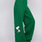 sideview of model wearing kelly green sweatpants with slit pockets and woodstock and snoopy print on sides