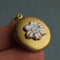 up close of brass forget me not flower locket necklace