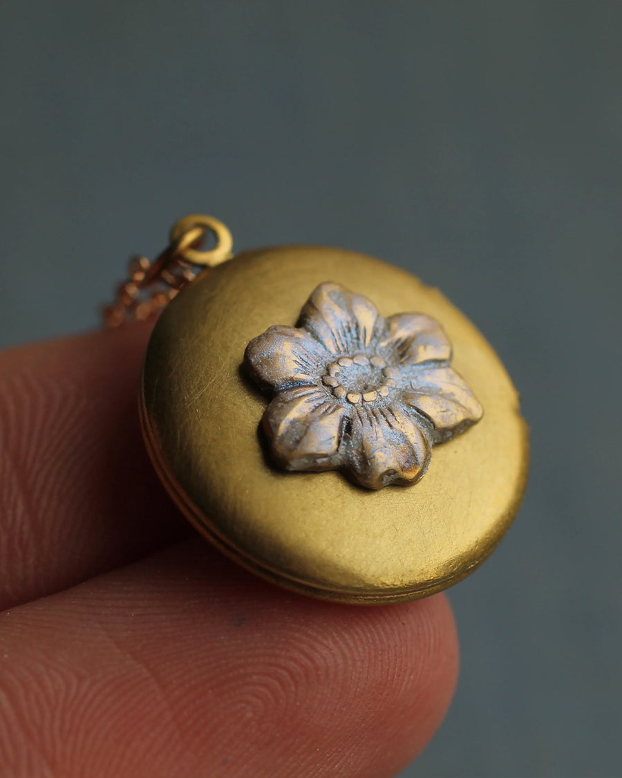 up close of brass forget me not flower locket necklace