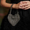 model wearing silver beaded heart shape bag