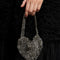 model wearing silver beaded heart shape bag