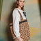 model wearing woven leopard print tote bag with black ricrac detail on the top