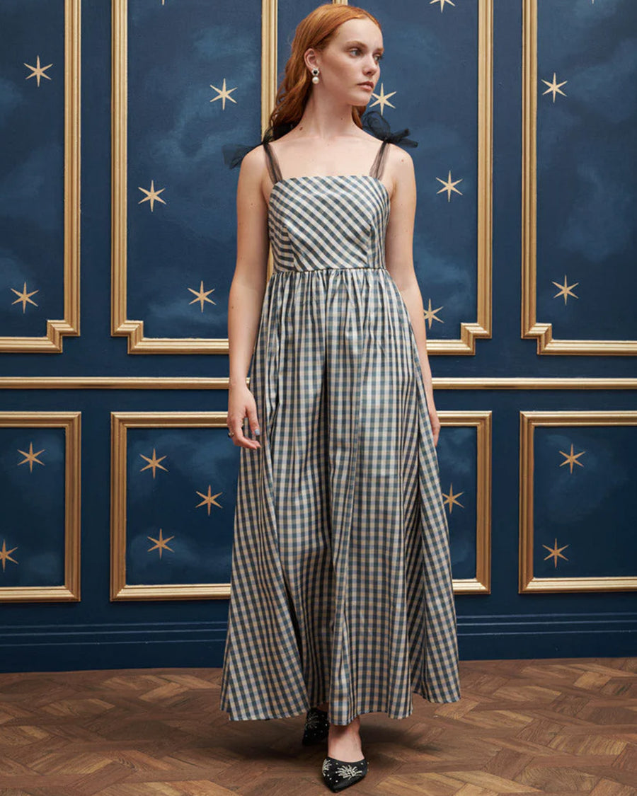 model wearing blue and white checkered dress with tulle straps