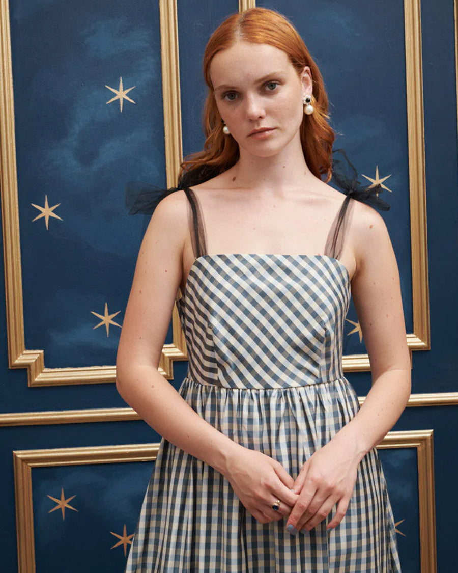 up close of model wearing blue and white checkered dress with tulle straps