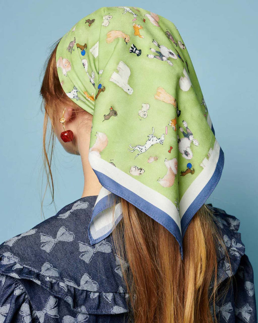 back view of model wearing green headscarf with all over dog print