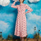 model wearing light pink midi dress with long sleeves, front yoke and tie and pink cowboy hat print