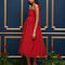 side view of model wearing red tulle midi dress with velvet tie straps and smocked bodice