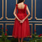 back view of model wearing red tulle midi dress with velvet tie straps and smocked bodice