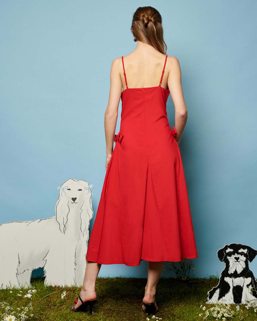 back view of model wearing red midi dress with bows on the waist