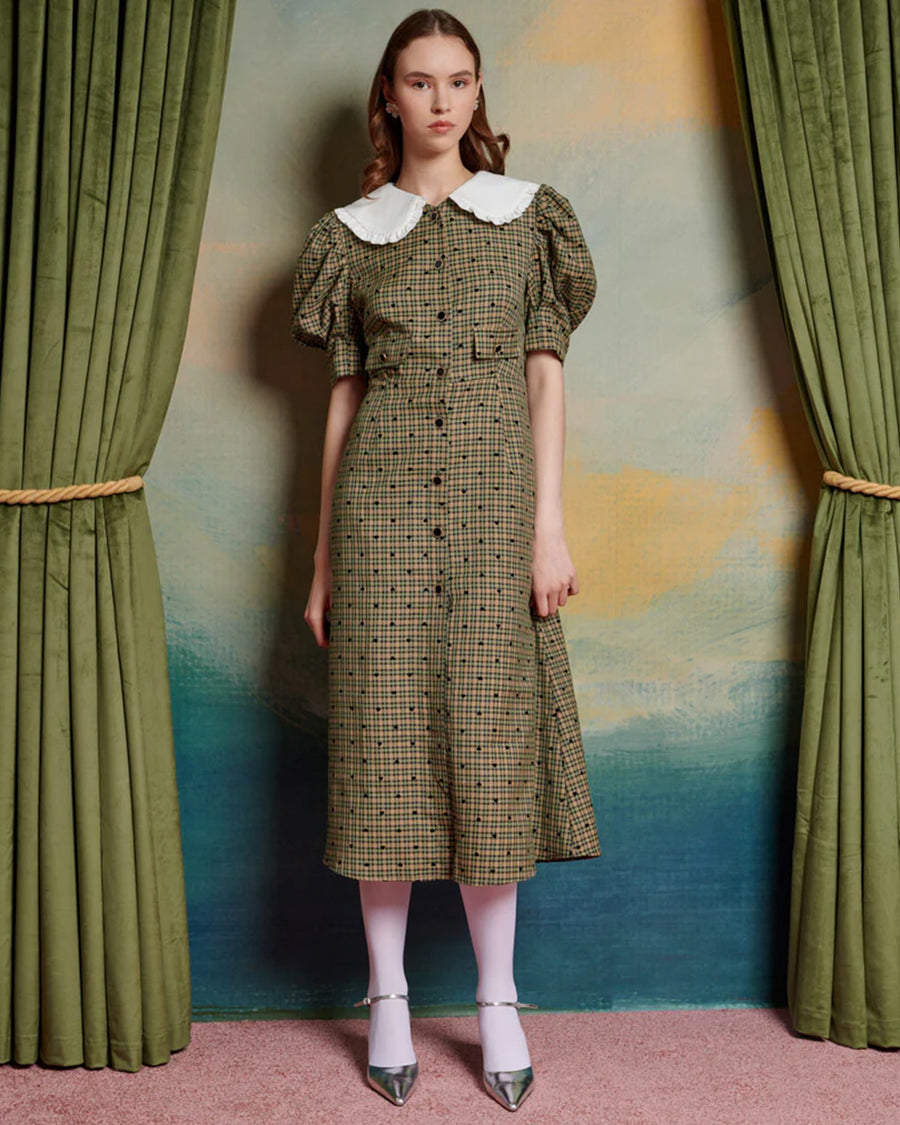 model wearing green check and heart print midi dress with puff sleeves and white oversize collar, and button front