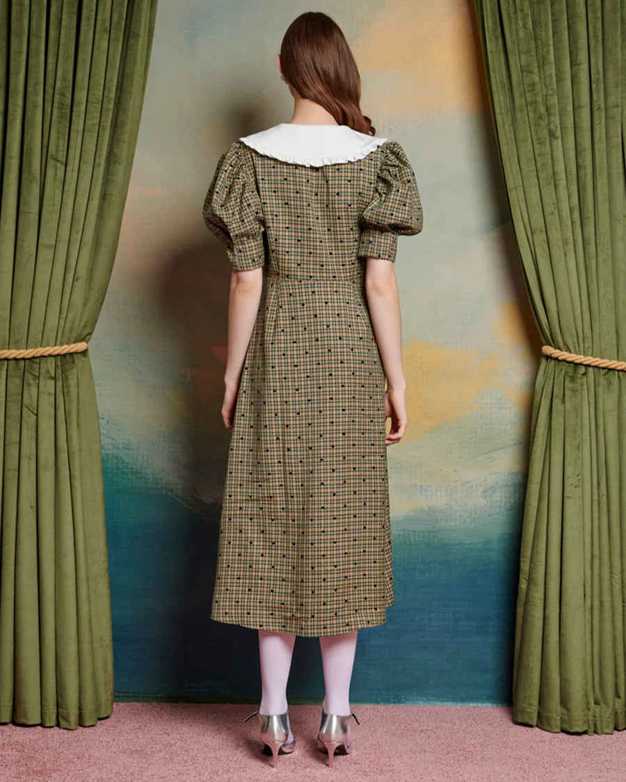 back view of model wearing green check and heart print midi dress with puff sleeves and white oversize collar, and button front