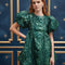 model wearing emerald green jacquard mini dress with puff sleeves and bubble hem