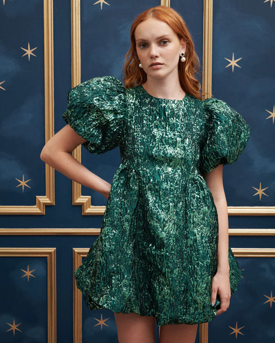 model wearing emerald green jacquard mini dress with puff sleeves and bubble hem