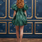 back view of model wearing emerald green jacquard mini dress with puff sleeves and bubble hem