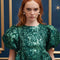 up close of model wearing emerald green jacquard mini dress with puff sleeves and bubble hem