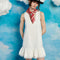 model wearing white mini dress with ruffle hem and deep v neckline