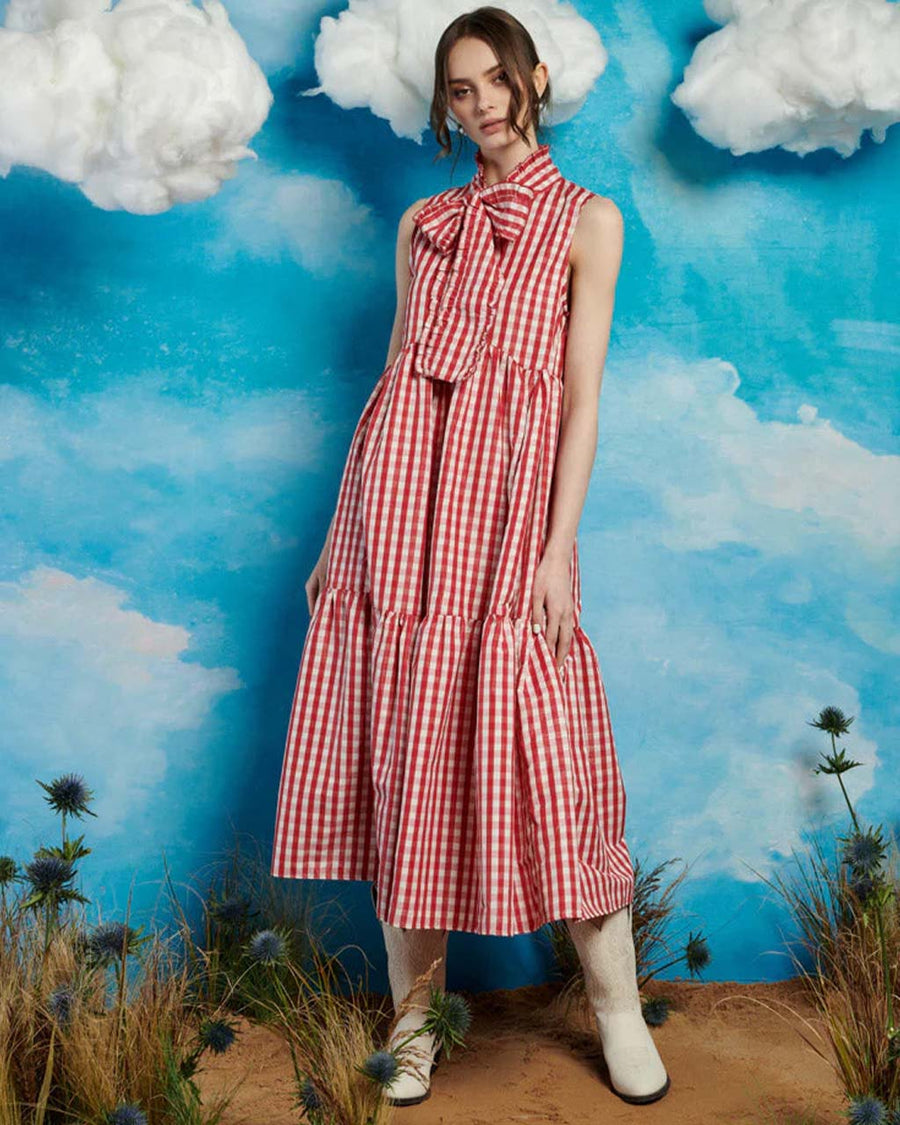 model wearing red and white gingham maxi dress with tiered skirt and oversized bow