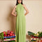 model wearing green dress with subtle shine, ruffle trim and halter neckline