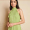 up close of model wearing green dress with subtle shine, ruffle trim and halter neckline