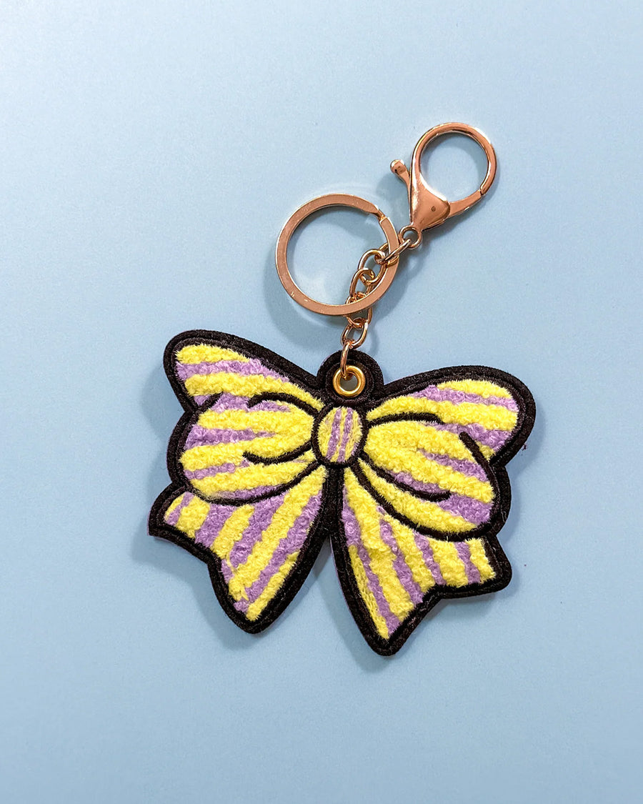 yellow and purple striped keychain with oversized chenille bow